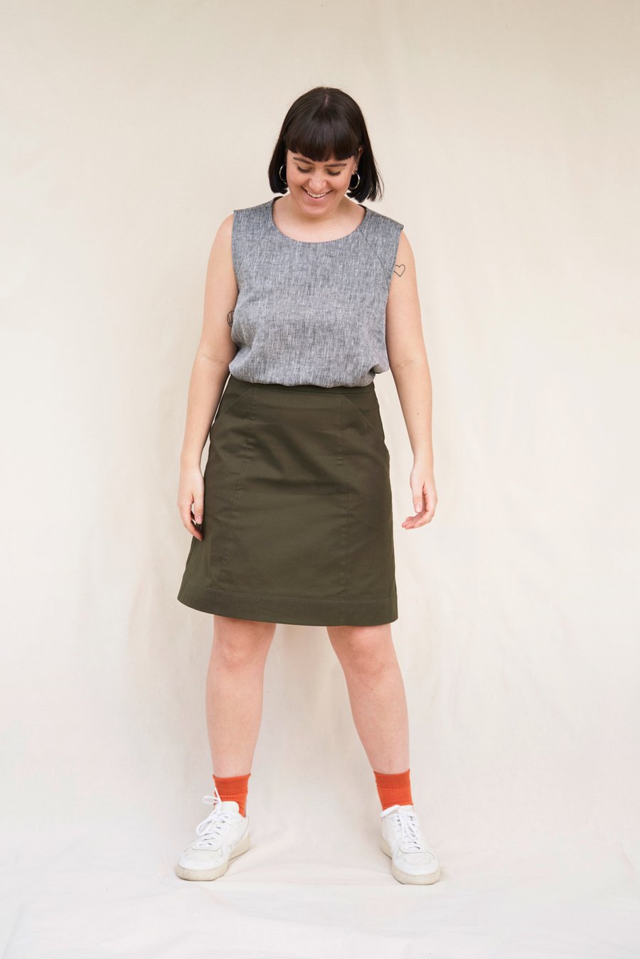 Woman wearing the Barkly Skirt pattern from In the Folds on The Fold Line. A skirt pattern made in linen, cotton canvas, cotton drill, denim, corduroy or wool fabrics, featuring an A-Line silhouette, front slanted pockets, waistband, insets in the side pa