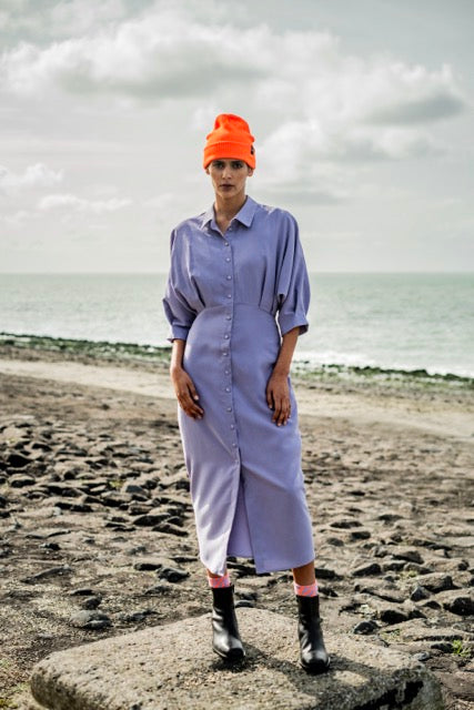 Woman wearing the Beryl Dress sewing pattern from Fibre Mood on The Fold Line. A shirt dress pattern made in lyocell, poplin, viscose (crepe) and seersucker fabrics, featuring a midi length, grown-on cropped sleeves with pleated hems, button front closure