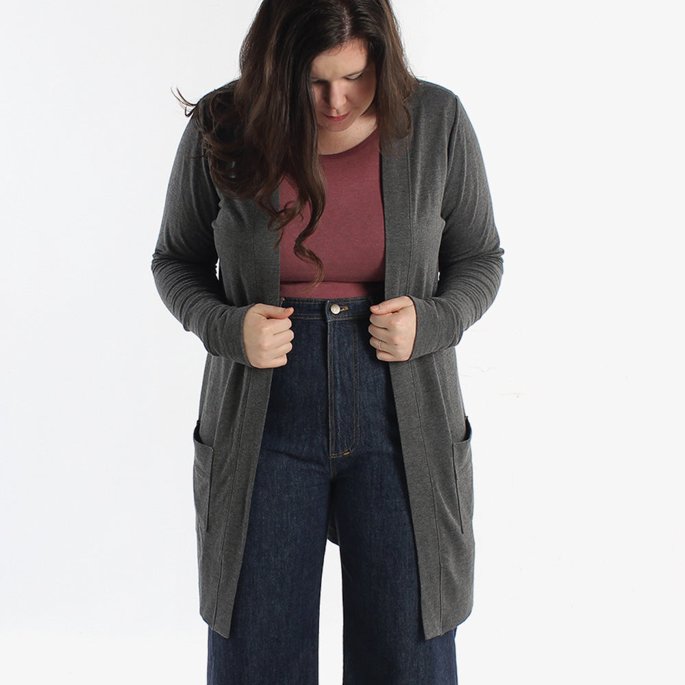 Woman wearing the Blackwood Cardigan sewing pattern from Helen's Closet on The Fold Line. A cardigan pattern made in light to medium weight knit fabrics, featuring minimal excess fabric in the front, close fit around the neck and shoulders, extra-long sle