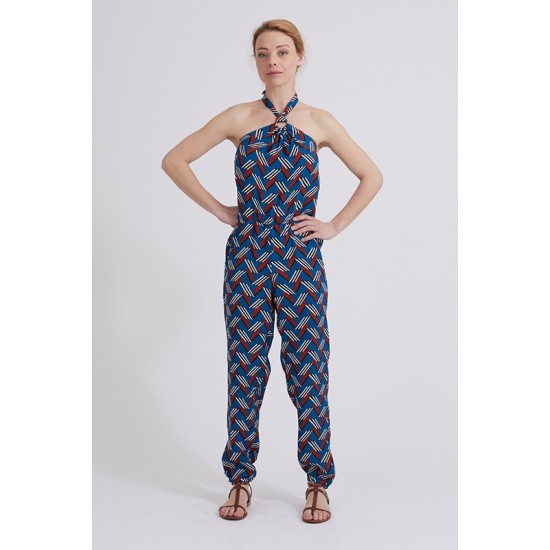 Woman wearing the Aude Jumpsuit sewing pattern from Coralie Bijasson on The Fold Line. A jumpsuit pattern made in crepe, linen, double gauze, or cotton fabric, featuring a halter neckline, open back, elastic waist, and pockets.