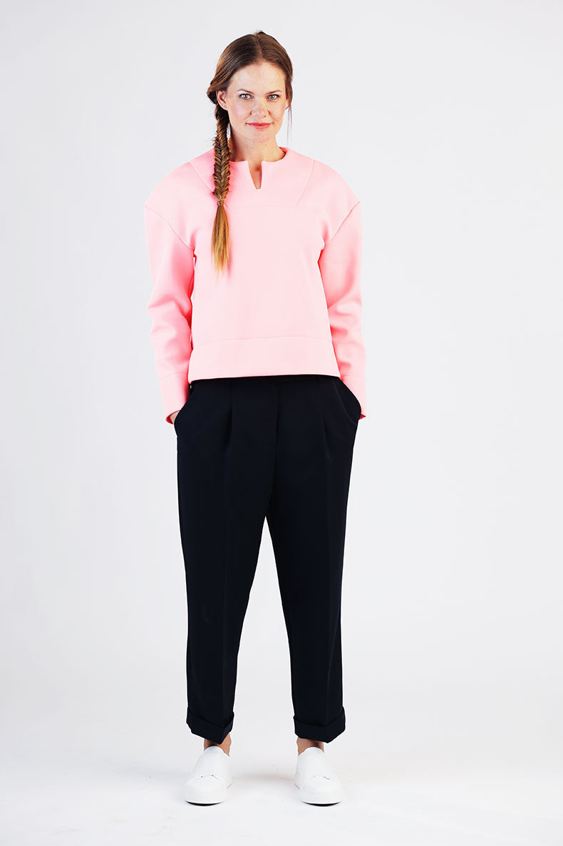 Woman wearing the Betty Top sewing pattern from Schnittchen Patterns on The Fold Line. A top pattern made in sweatshirt, neoprene, or jersey knit fabric, featuring a relaxed fit, dropped shoulders, and top-stitched facing.