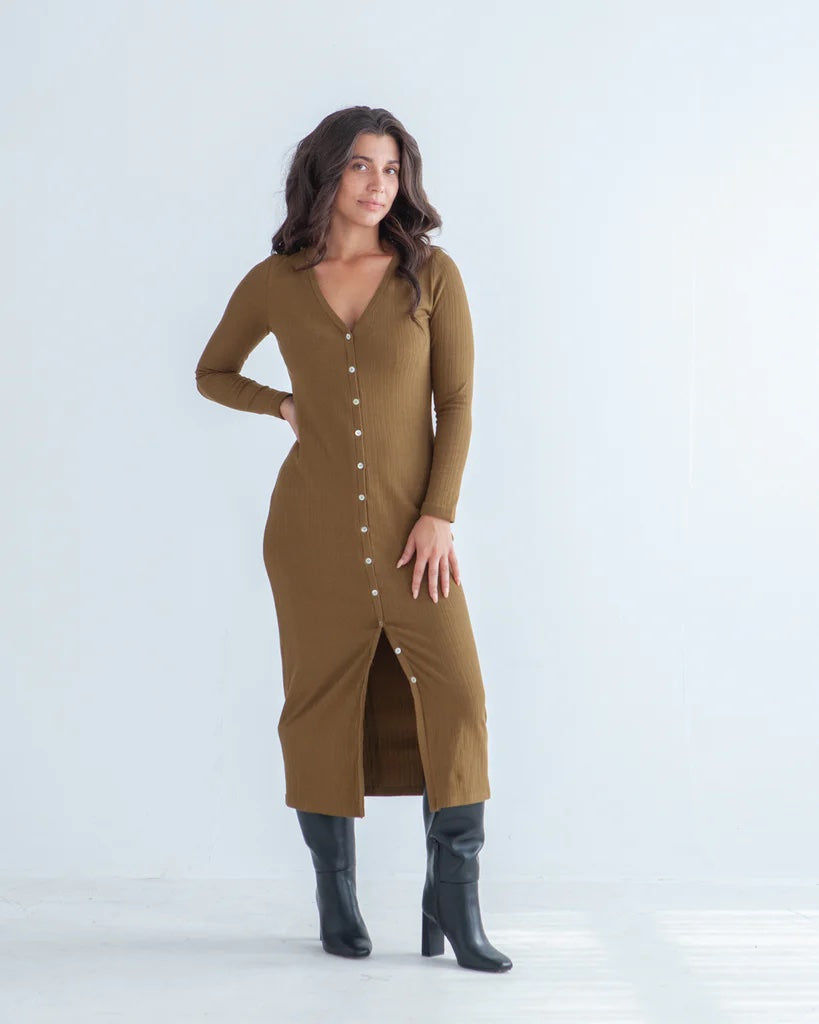 Woman wearing the Brynn Cardigan sewing pattern from True Bias on The Fold Line. A cardigan pattern made in rib knit, sweater knit, or jersey fabric, featuring a fitted silhouette, V-neck, front button opening, long sleeves, and midi dress length.