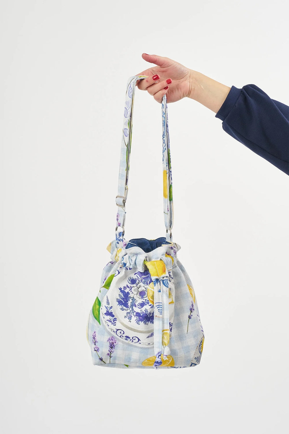 The Bucket Bag sewing pattern from Sew Over It on The Fold Line. A bag pattern made in cotton twill, cotton canvas, or denim fabric, featuring a classic drawstring fastening, flat base, full lining, inside pocket, and adjustable strap.