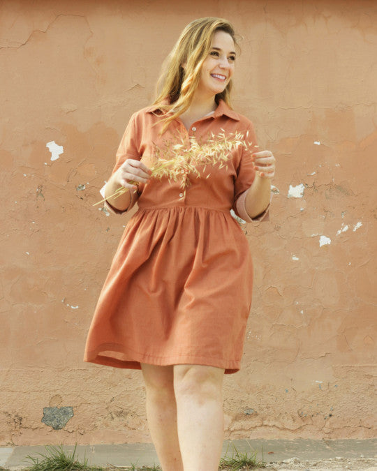 Woman wearing the Camí Dress sewing pattern from Pauline Alice on The Fold Line. A shirt dress pattern made in cotton poplin, linen, chambray, or rayon fabric, featuring a collar, button front, mid-length sleeves, gathered skirt, and knee length.