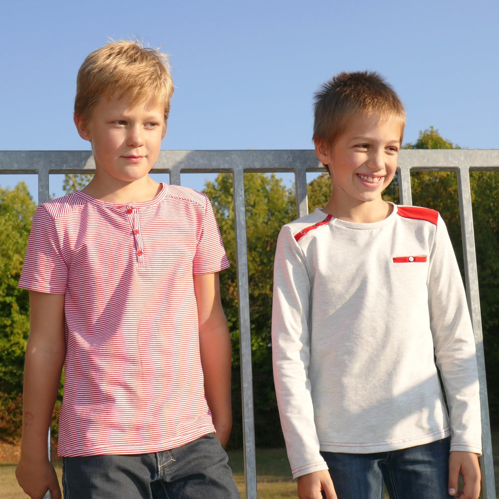Boys wearing the Child/Teen Sinbad T-shirt sewing pattern from Petits D'om on The Fold Line. A t-shirt pattern made in jersey fabric, featuring a henley neckline or shoulder snaps, short or long sleeves, and an optional chest pocket.