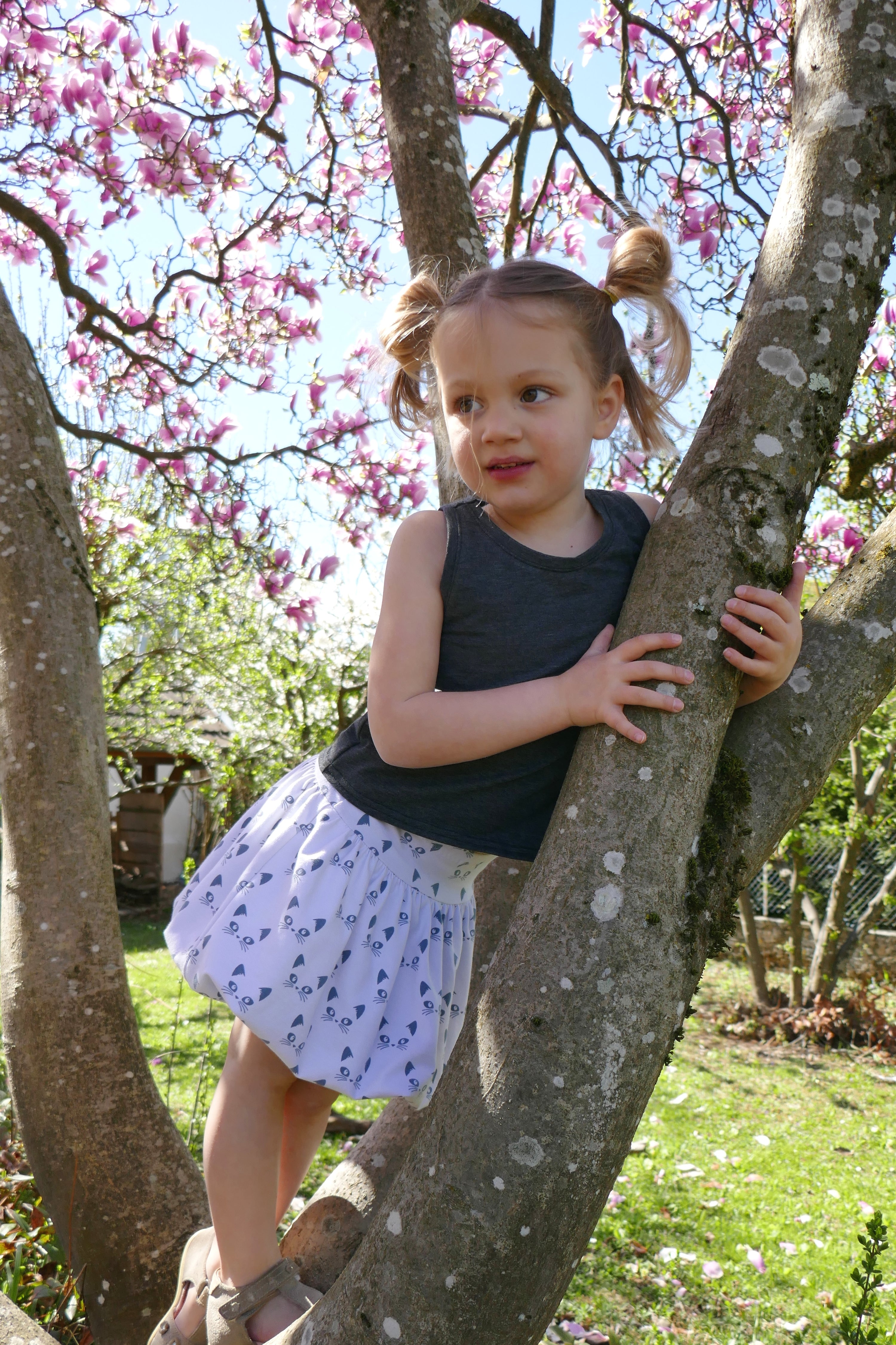 Girl wearing the Child/Teen Zeepbel Bubble Skirt sewing pattern from Petits D'om on The Fold Line. A skirt pattern made in jersey fabric, featuring a wide waistband with elastic and a fun bubble shape.