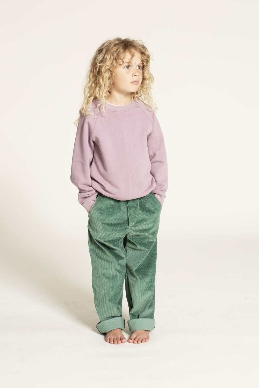 Child wearing the Children’s Sweatshirt sewing pattern from Wardrobe by Me on The Fold Line. A sweatshirt pattern made in french terry or sweatshirt fabric, featuring a crew neck and long raglan sleeves.