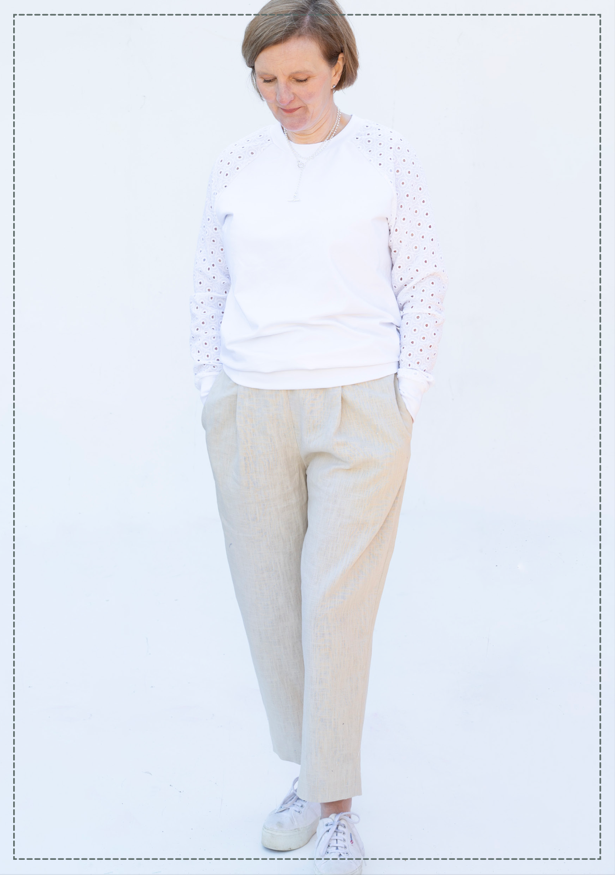 Woman wearing the Compton Trousers sewing pattern from Bobbins and Buttons on The Fold Line. A pants pattern made in linen, light or medium weight denim, cotton or gabardine fabric, featuring a relaxed fit, elasticated waistband, front pleats, side pockets, tapered leg, and ankle length.