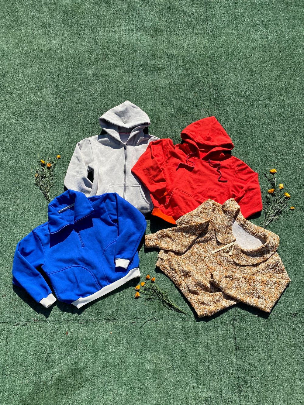 The Dale Sweatshirt Expansion sewing pattern from Daisy Chain Patterns on The Fold Line. A sweatshirt and hoodie pattern made in sweatshirt fleece, french terry, or sweater knit fabric, featuring a pull-on or zip front hoodie with a kangaroo pocket, a quarter zip top with a wide collar and side seam pockets, or a sweatshirt with a peter pan collar and tie front.