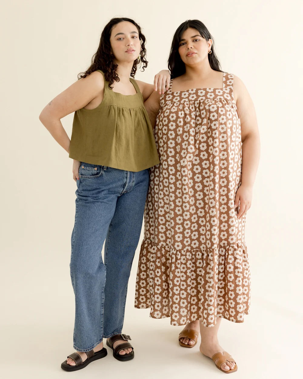 Women wearing the Daphne Dress and Top sewing pattern from BF Patterns on The Fold Line. A dress and top pattern made in cotton lawn, batiste, poplin, lightweight linen, linen blend, cotton seersucker, or double gauze fabric, featuring a crop top and maxi dress, both with wide straps, a square neckline, and gathering under the front and back yokes.