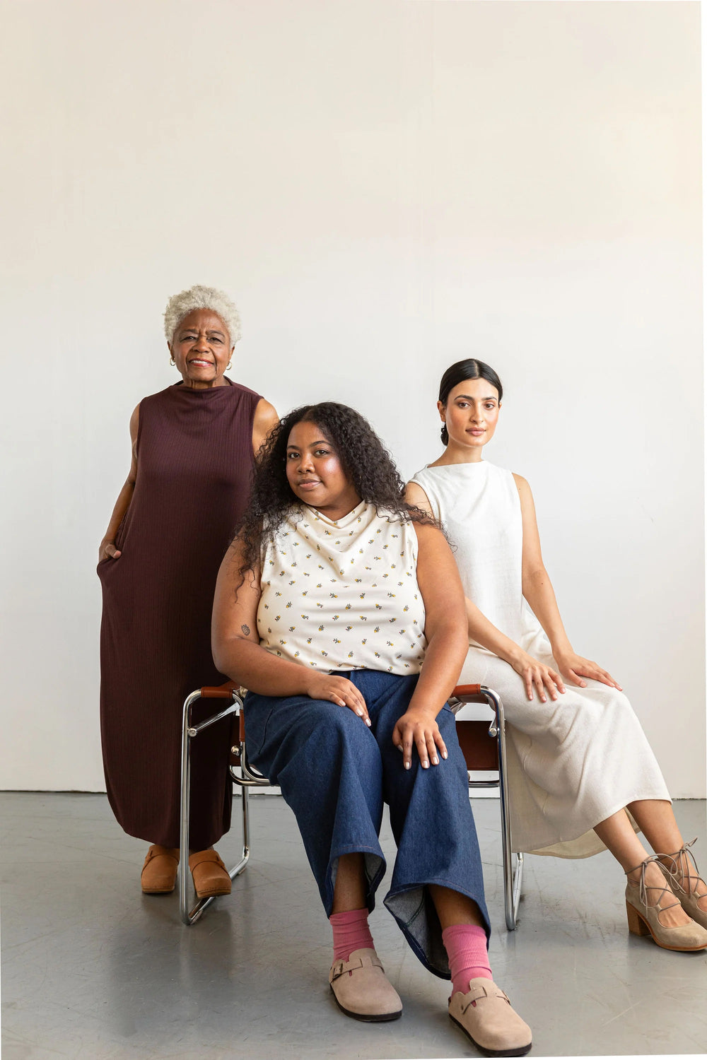 Women wearing the Dew Top and Dress sewing pattern from Friday Pattern Company on The Fold Line. A sleeveless top and dress pattern made in jersey, rib knit, ponte knit, or scuba fabric, featuring a cowl neck, shaped hem, and pockets for the dress.