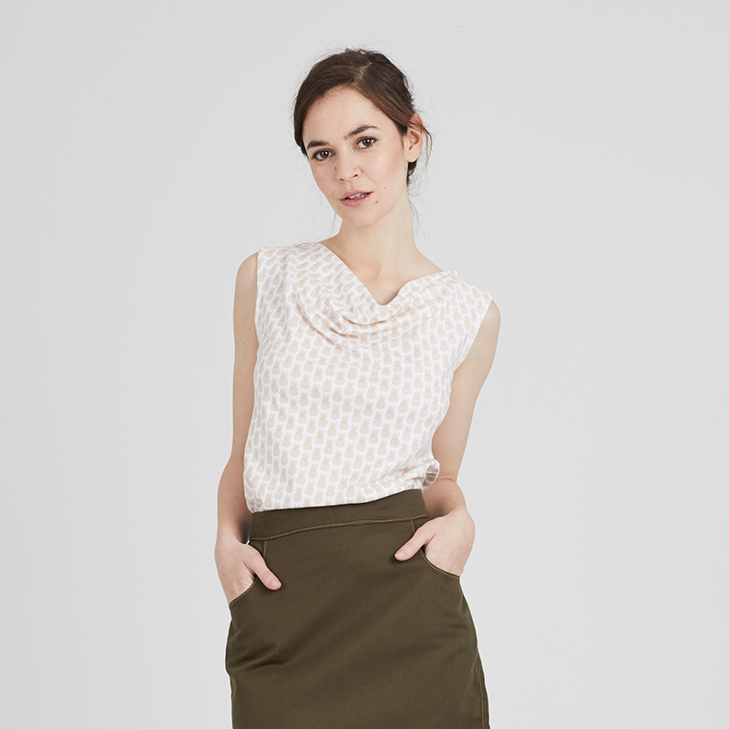 Woman wearing the Emno T-shirt sewing pattern from Coralie Bijasson on The Fold Line. A sleeveless tee pattern made in jersey knit fabric, featuring a draped cowl neckline.