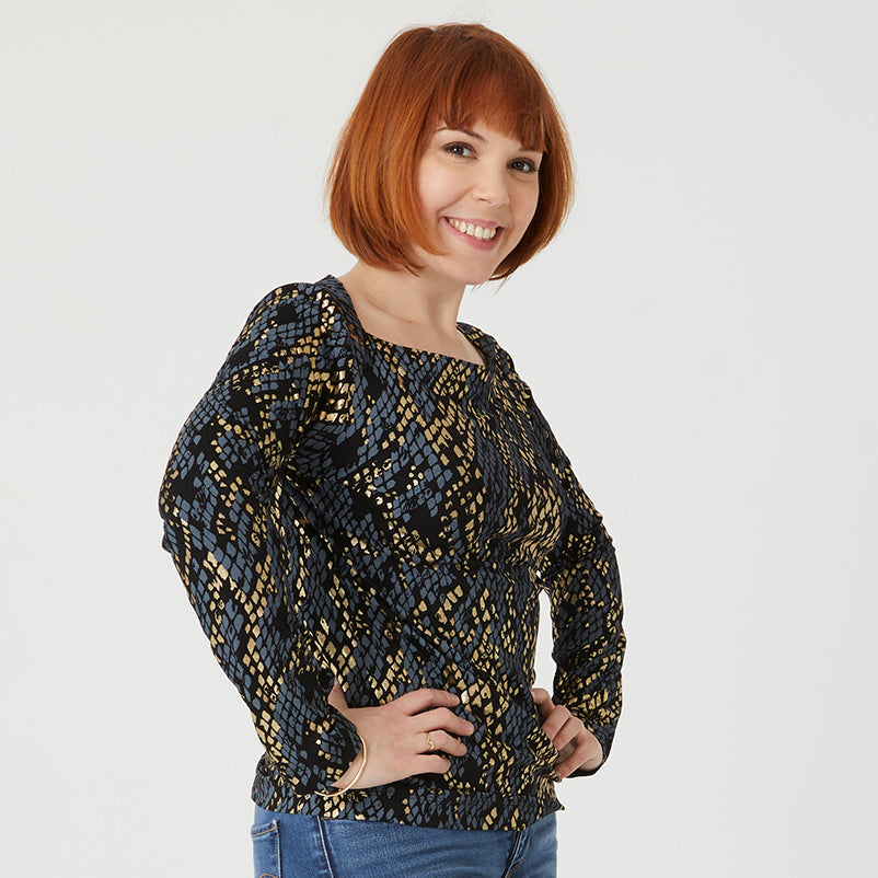 Woman wearing the Esmeralda T-shirt sewing pattern from Coralie Bijasson on The Fold Line. A tee pattern made in jersey knit fabric, featuring a slash neckline and long sleeves.