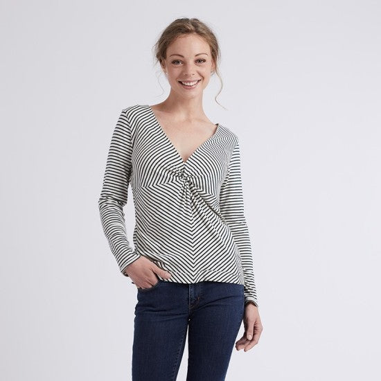 Woman wearing the Espérance T-shirt sewing pattern from Coralie Bijasson on The Fold Line. A T-shirt pattern made in knit fabric, featuring a deep V-neckline with a twist detail and long sleeves.