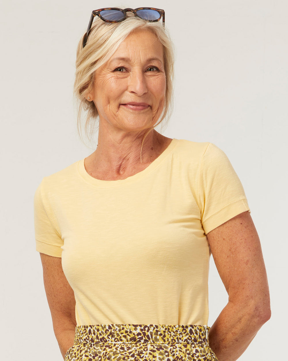 Woman wearing the Essentiel T-shirt sewing pattern from Coralie Bijasson on The Fold Line. A T-shirt pattern made in knit fabric, featuring a round neckline and short sleeves.
