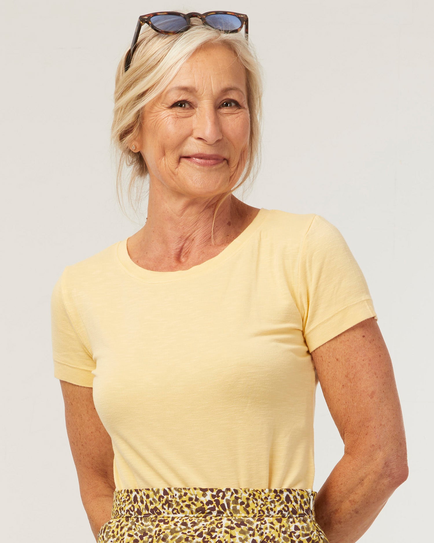 Woman wearing the Essentiel T-shirt sewing pattern from Coralie Bijasson on The Fold Line. A T-shirt pattern made in knit fabric, featuring a round neckline and short sleeves.