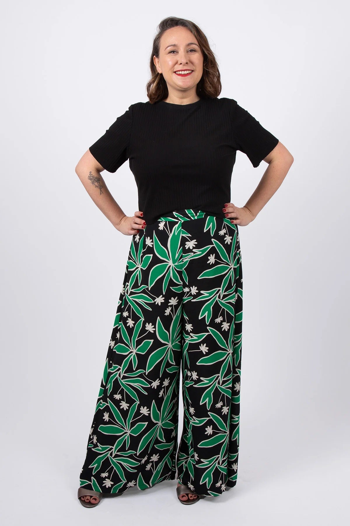 Woman wearing the Hazel Trousers sewing pattern from Sew Over It on The Fold Line. A trousers pattern made in linen, crepe, suiting wool, viscose linen, or rayon fabric, featuring a waistband with belt loops, darts, invisible zip, and wide leg.