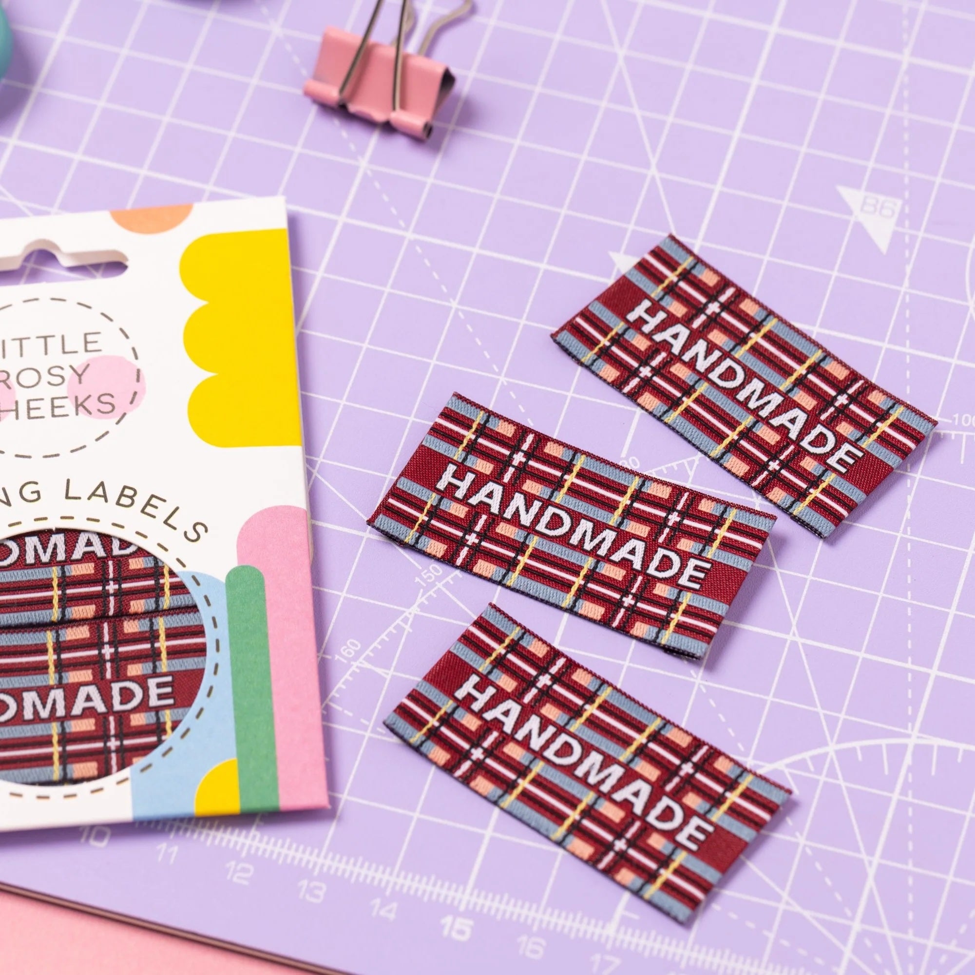 The 'Highland Handmade' woven labels from Little Rosy Cheeks on The Fold Line. The pack includes 6 labels featuring snowy white text on a rich autumnal tartan, ready to be sewn into your handmade clothes.