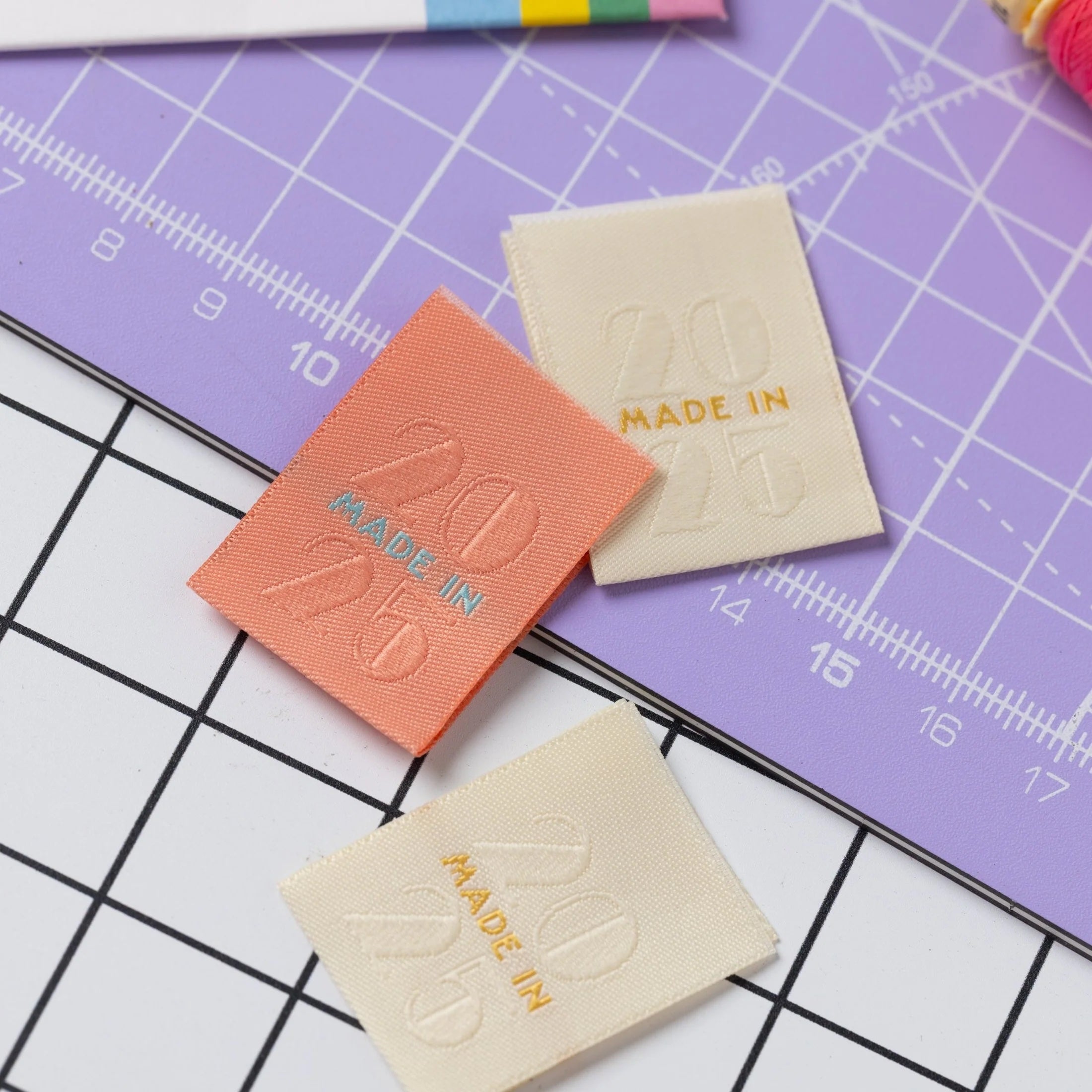 The 'Made in 2025' woven labels from Little Rosy Cheeks on The Fold Line. The pack includes 6 embossed woven labels in peach and cream ready to be sewn into your handmade clothes.