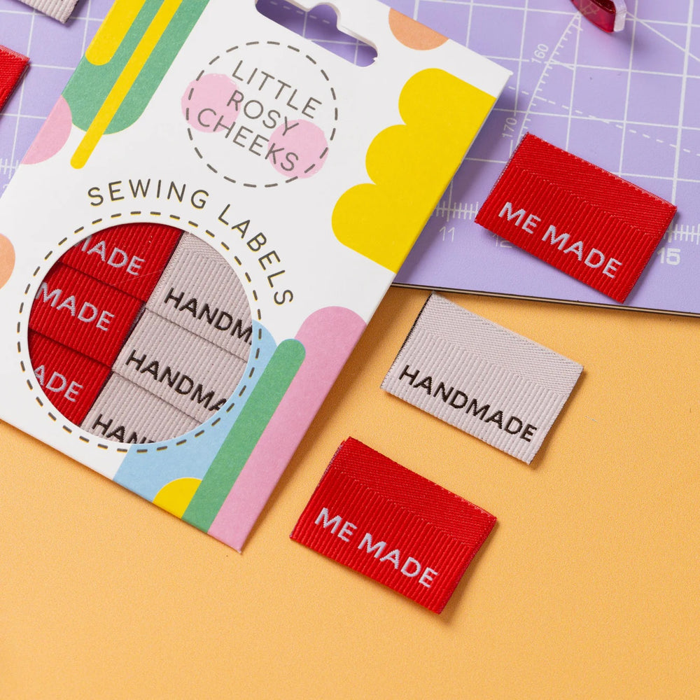 The 'Me Made / Handmade Ribbed' woven labels from Little Rosy Cheeks on The Fold Line. The pack includes 6 labels in red and oyster pink with a 3D ribbed texture, ready to be sewn into your handmade clothes.