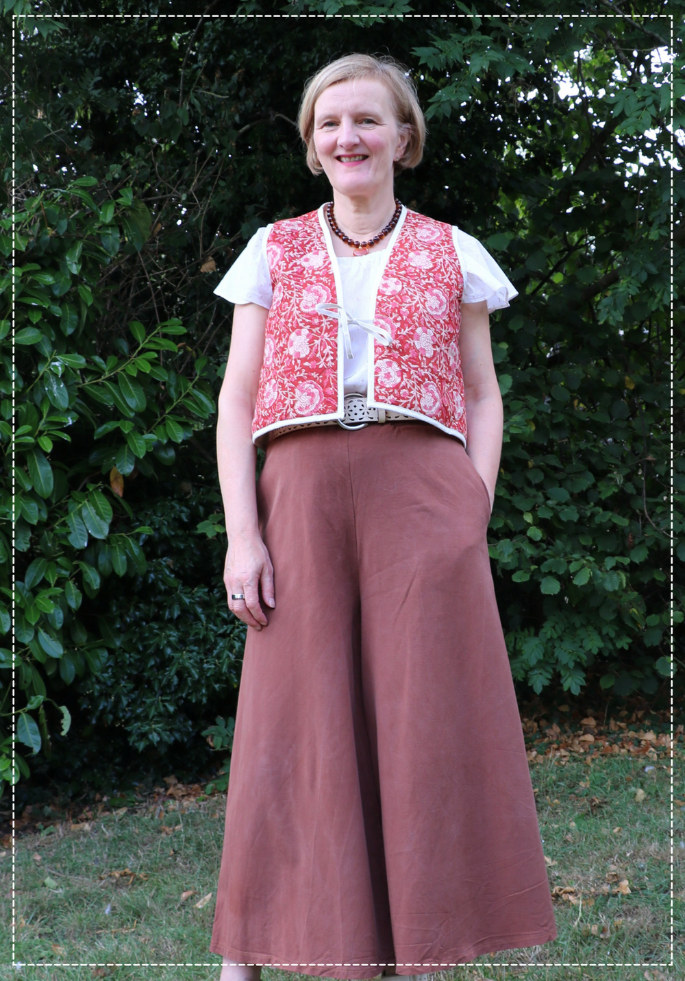Woman wearing the Press Waistcoat sewing pattern from Bobbins and Buttons on The Fold Line. A waistcoat pattern made in cotton, linen, denim, or wool fabric, featuring front ties and bias bound edges.