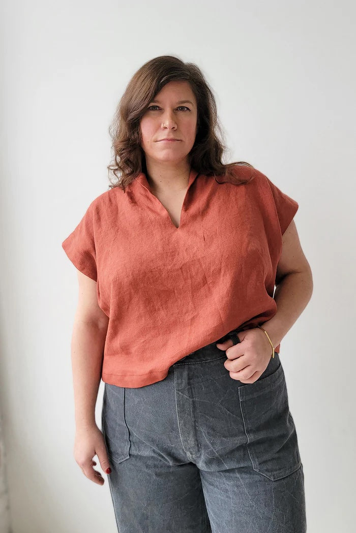 Woman wearing the Revel Topper sewing pattern from Sew House Seven on The Fold Line. A top pattern made in linen, viscose/linen blends, Ecovero challis, or Tencel chambray fabric, featuring a loose fit, shawl collar, collar facing, and short cut-on sleeves.