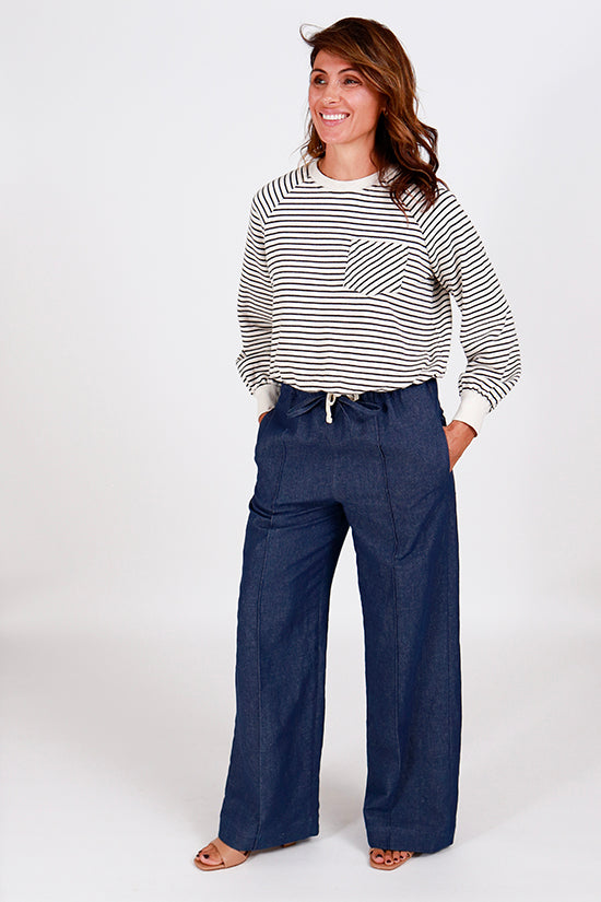 Woman wearing the Reya Pants and Shorts sewing pattern from Chalk and Notch on The Fold Line. A pants pattern made in hemp, linen, rayon, twill blend, or wool fabric, featuring a mid rise, elastic and drawstring waist, front pin tuck detail, and pockets.