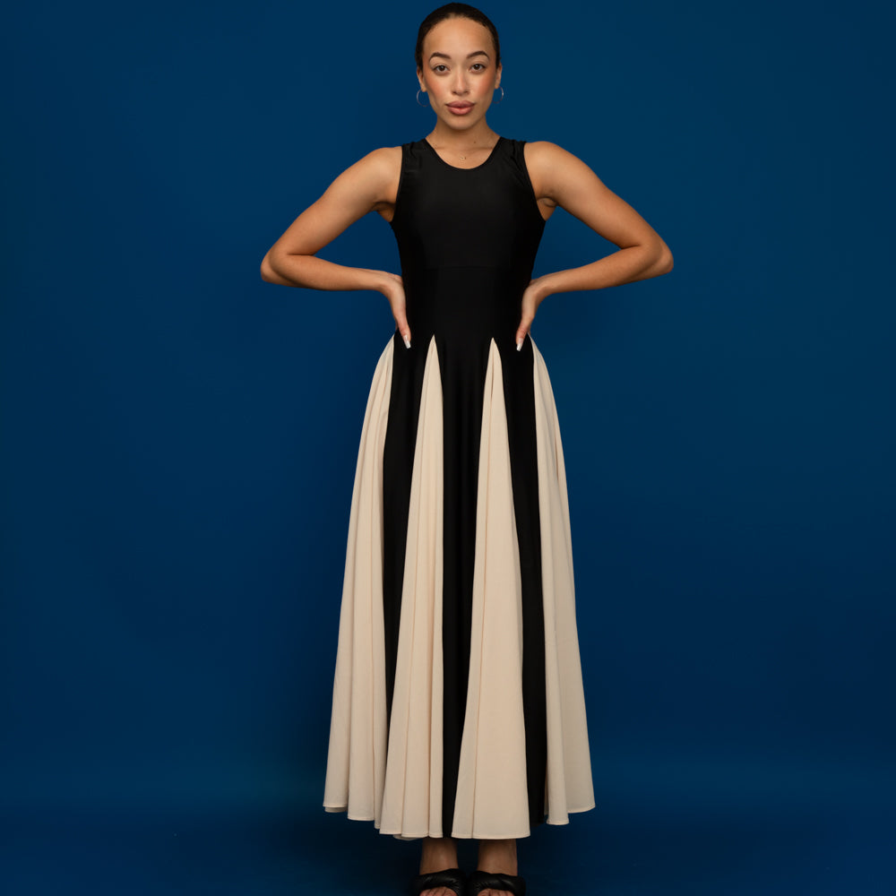 Woman wearing the Scarlett Maxi Dress sewing pattern from Madalynne on The Fold Line. A sleeveless dress pattern made in lycra, stretch velvet, stretch all over lace, knit, or jersey, and voile, crepe, or china silk fabric, featuring a fitted bodice with an empire seam and bust darts, and a skirt with six godets for the ultimate flared hem.