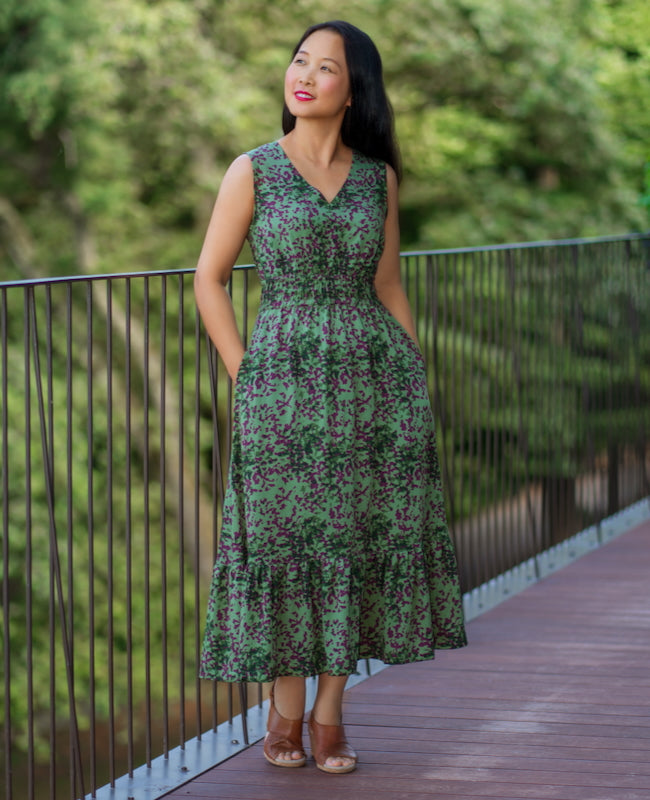 Woman wearing the Sorata Dress sewing pattern from Itch to Stitch on The Fold Line. A sleeveless dress pattern made in shirting, rayon challis, batiste, chambray, lightweight linen, or lightweight broadcloth fabric, featuring a V-neckline, elasticised waist, in-seam pockets, and ruffle hem.