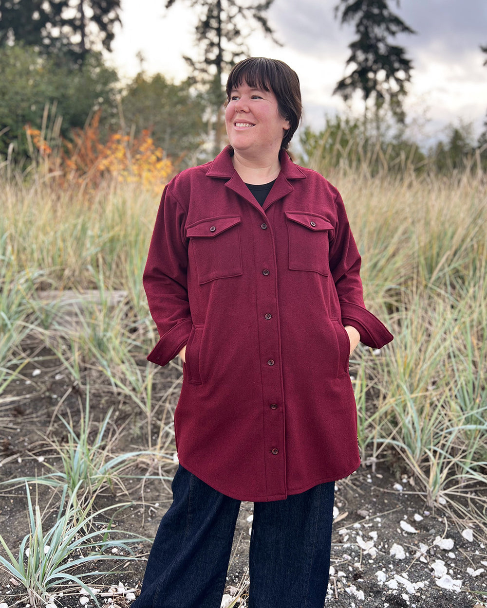 Woman wearing the Spindrift Jacket sewing pattern from Helen's Closet on The Fold Line. A jacket pattern made in denim, cotton or linen twill, corduroy, canvas, jacquard or wool fabric, featuring a relaxed fit, dropped shoulder, collar, patch and welt pockets, longer length, and scooped hem.