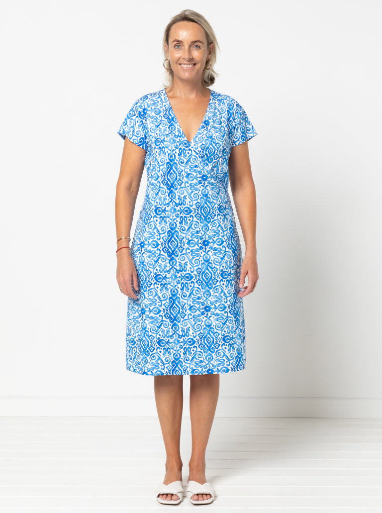 Woman wearing the Suzie Knit Dress sewing pattern from Style Arc on The Fold Line. A dress pattern made in jersey knit fabric, featuring a faux wrap front, deep V-neckline, short sleeves, and knee length.