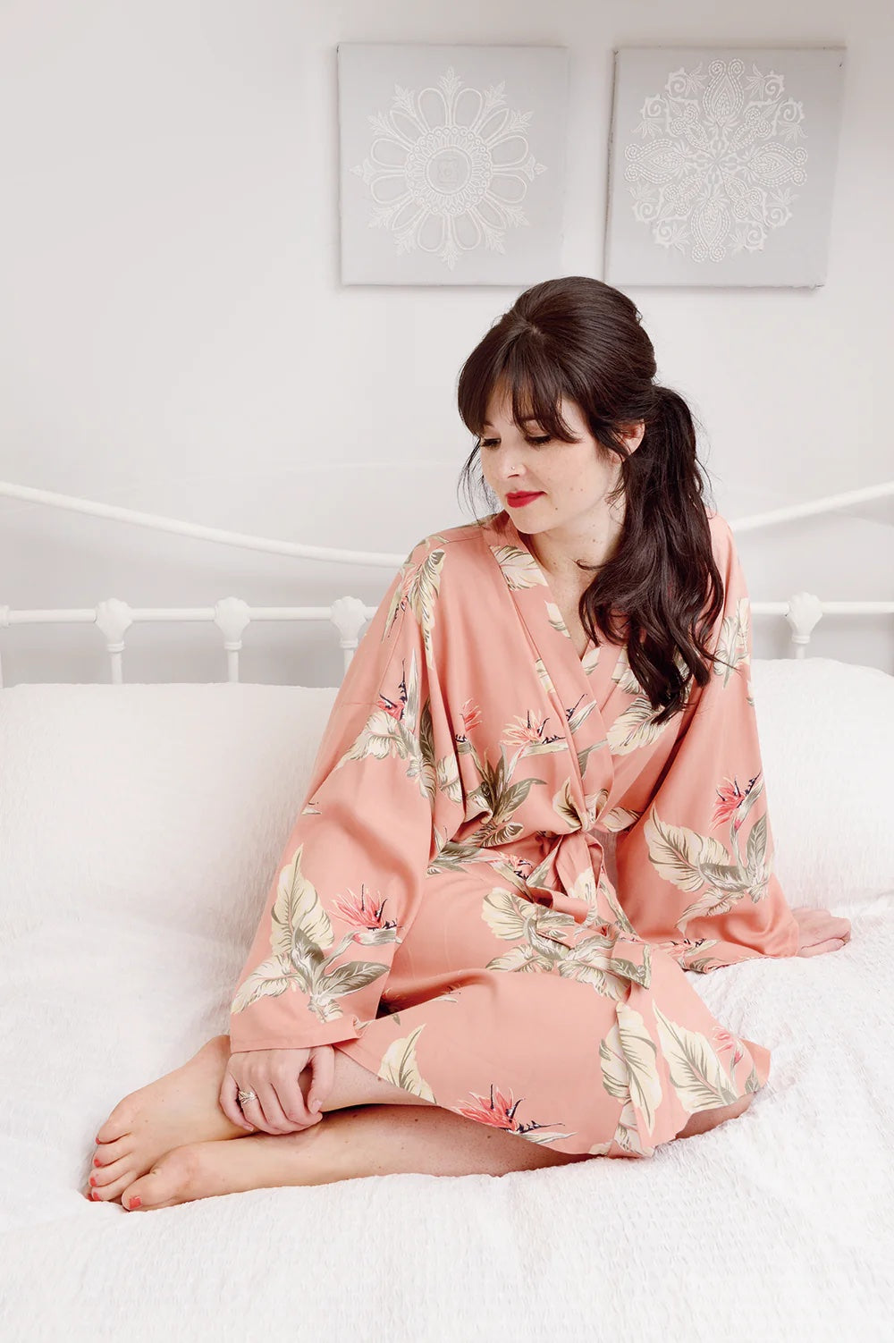 Woman wearing the Sylvia Robe Dressing Gown Add-on sewing pattern from Sew Over It on The Fold Line. A dressing gown pattern made in viscose, silk, crepe, waffle, or light terry towelling fabric, featuring a wrap silhouette with a tie belt.