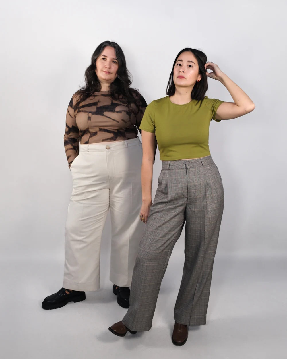 Women wearing the Taylor Trousers sewing pattern from BF Patterns on The Fold Line. A trousers pattern made in wool and poly blend suiting, linen, cotton twill, denim, or canvas fabric, featuring a high waist, pleated or flat front, zipper fly, straight leg, and pockets.