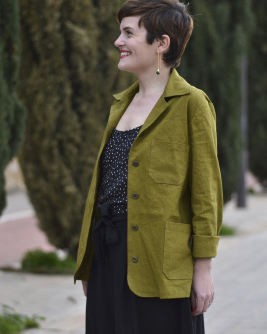 Woman wearing the Tello Jacket sewing pattern from Pauline Alice on The Fold Line. An unlined utility jacket pattern made in gabardine, canvas, linen, twill, denim, or corduroy fabric, featuring a topstitched collar, front button closure, one-piece sleeve with an elbow dart, and pockets.