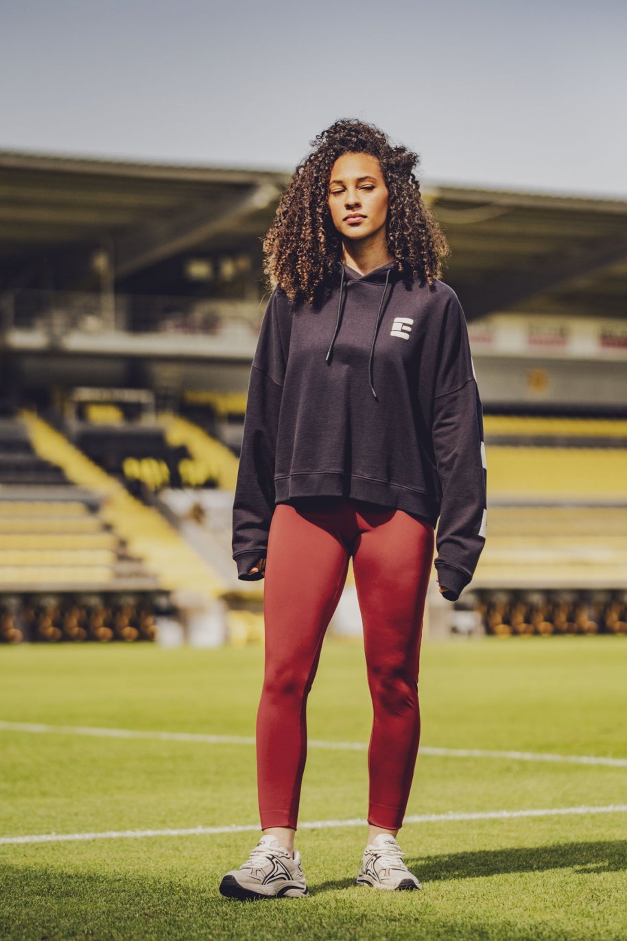 Woman wearing the Yuki Leggings sewing pattern from Fibre Mood on The Fold Line. A leggings pattern made in tricot, jersey, or French terry fabric, featuring a fitted cut and wide waistband.