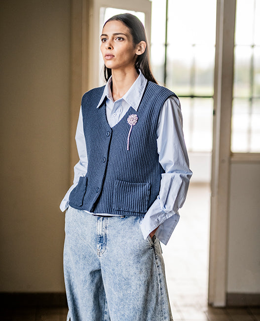 Woman wearing the Zehra Waistcoat sewing pattern from Fibre Mood on The Fold Line. A waistcoat pattern made in corduroy, cotton twill, wool, or knit fabric, featuring a V-neck, button front, and pockets.