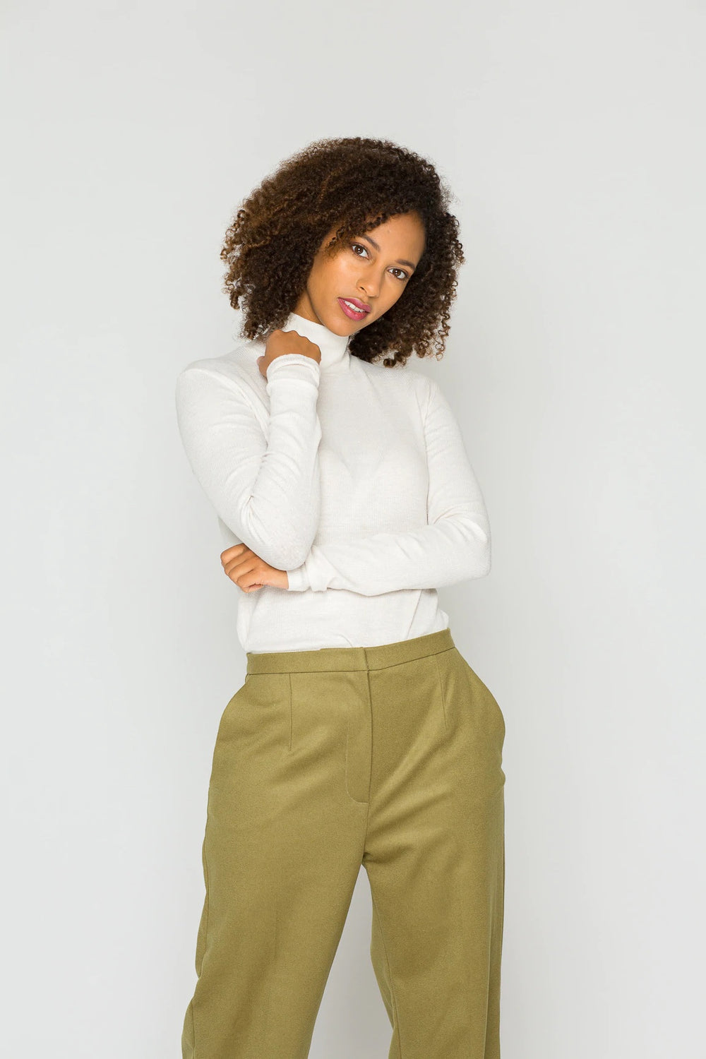 Woman wearing the Celine Longsleeve Top sewing pattern from Bara Studio on The Fold Line. A top pattern made in jersey, interlock or punta di roma fabrics, featuring a close fit, turtle neck and long sleeves.