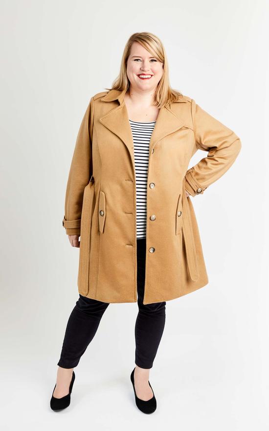 Woman wearing the Chilton Trench Coat sewing pattern by Cashmerette. A trench coat pattern made in gabardine or twill weave or waterproof raincoat fabric featuring a single breasted bodice, belted waist, button front, epaulettes, front pockets and double