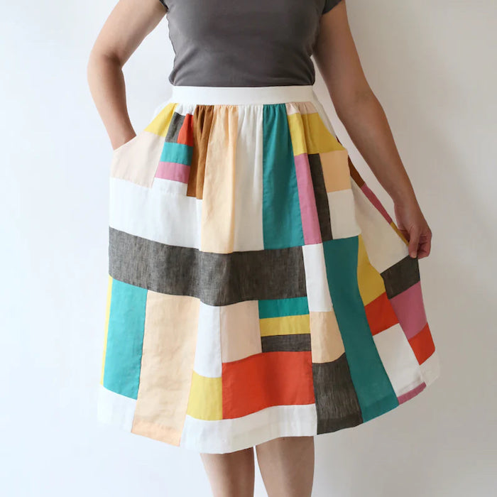 Woman wearing the Cleo Skirt sewing pattern from Made by Rae on The Fold Line. A skirt pattern made in lawn, voile, double gauze, poplin, shirting, rayon challis, sateen, silk, quilting cotton, linen, or cotton-linen blend fabrics, featuring a flat-front