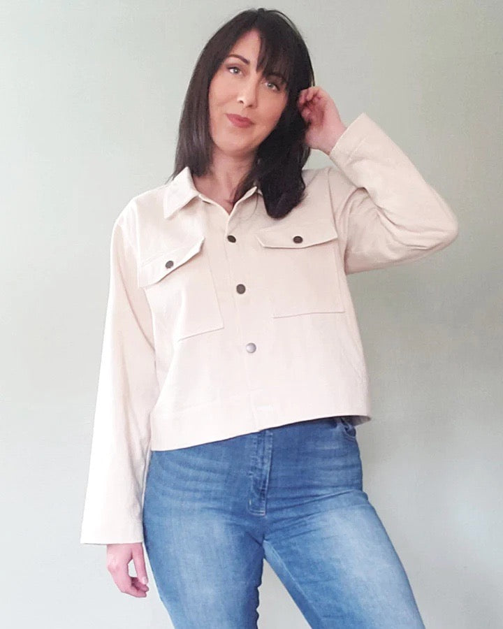 Woman wearing the Cozi Jacket Expansion Pack sewing pattern from Pattern Scout on The Fold Line. A jacket pattern made in denim, linen, or twill fabric, featuring a collar, button front, and pockets with flaps.