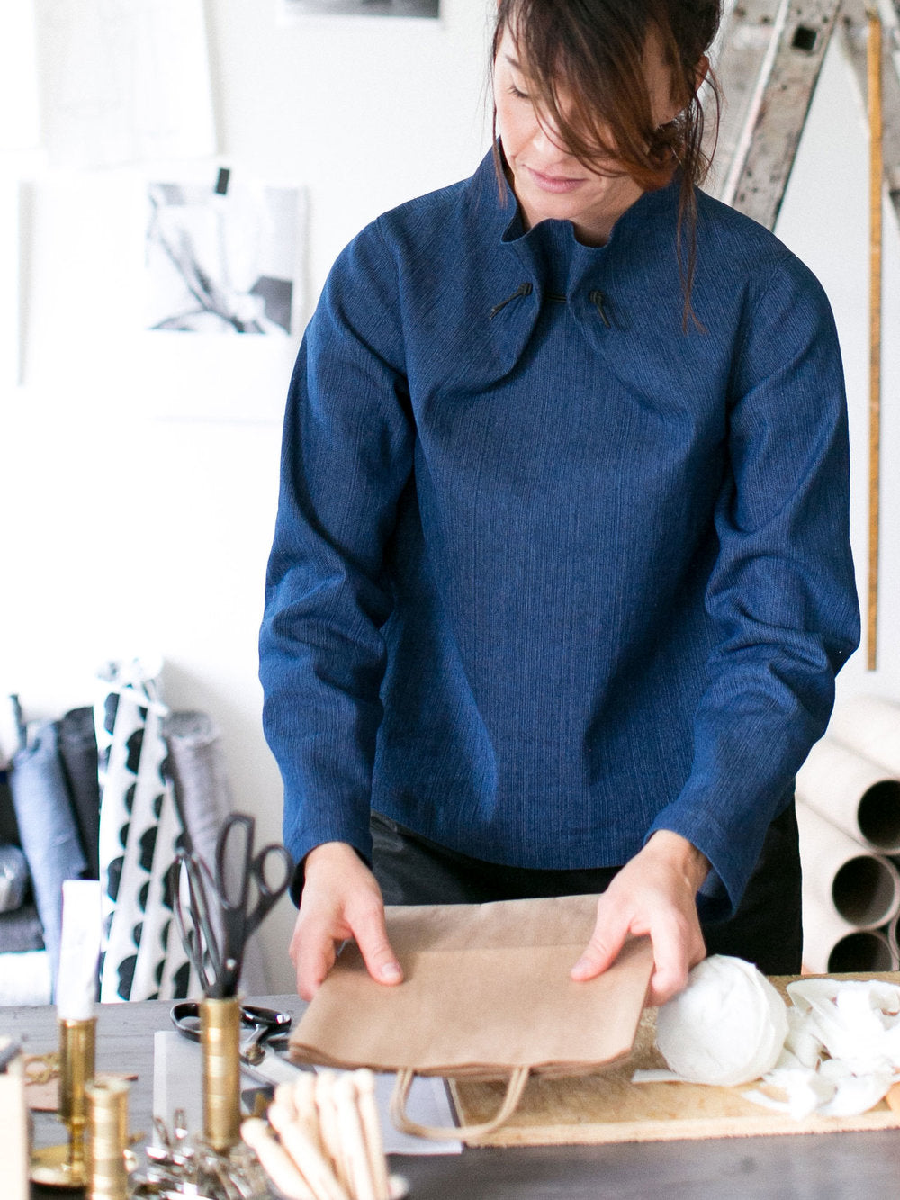 Woman wearing the Elastic Tie sweater sewing pattern by The Assembly Line. Loose fitting pattern made in cotton, denim or canvas fabrics featuring a high neck tightened with an elastic band.