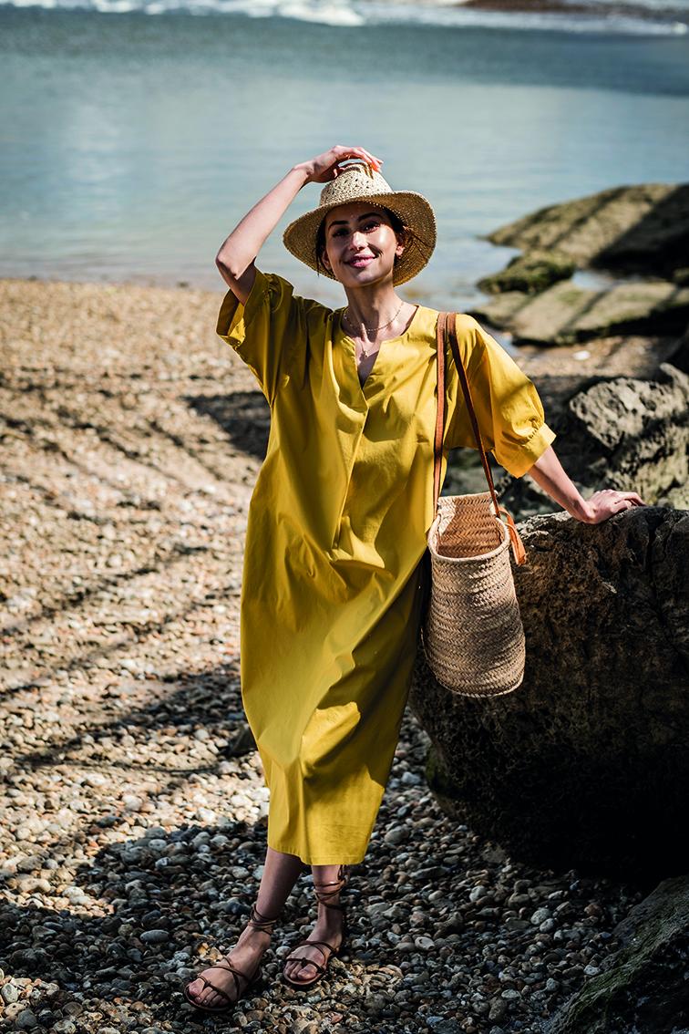 Women wearing the Mae Dress sewing pattern from Fibre Mood on The Fold Line. A dress pattern made in double gauze, crepe, lyocell, or silk fabrics, featuring a wavy hem, midi length, ¾ length sleeves with cuffs, oversized fit, midi length, and round neck