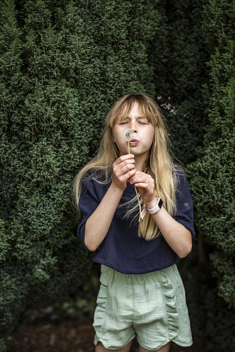 Child wearing the Child/Teen Lou Shorts sewing pattern from Fibre Mood on The Fold Line. A shorts pattern made in cotton, viscose, crepe or French terry fabrics, featuring an elastic waist, bias finish hemline, side slits with flounces and relaxed fit.