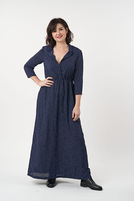 Woman wearing the Florence Dress sewing pattern from Sew Over It on The Fold Line. A dress pattern made in chiffon, rayon, crepe or georgette fabrics, featuring a button-up bodice, stand collar, 3/4 length set-in sleeves, elasticated waist, maxi lengths,