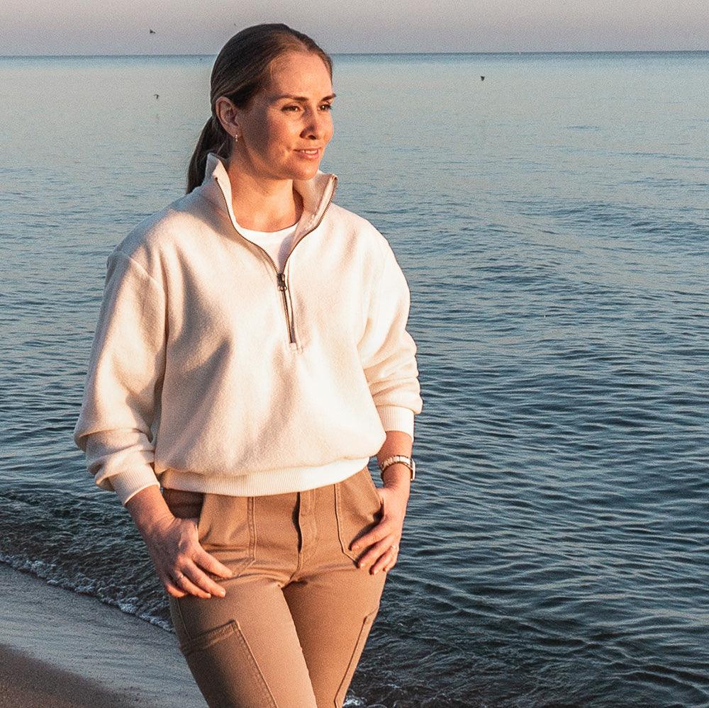 Woman wearing the Half Zipper Sweater sewing pattern from Wardrobe by Me on The Fold Line. A sweater pattern made in fleece, french terry or plush teddy fabrics, featuring a high collar, zipper from neck to chest, relaxed fit, dropped shoulders and set-in