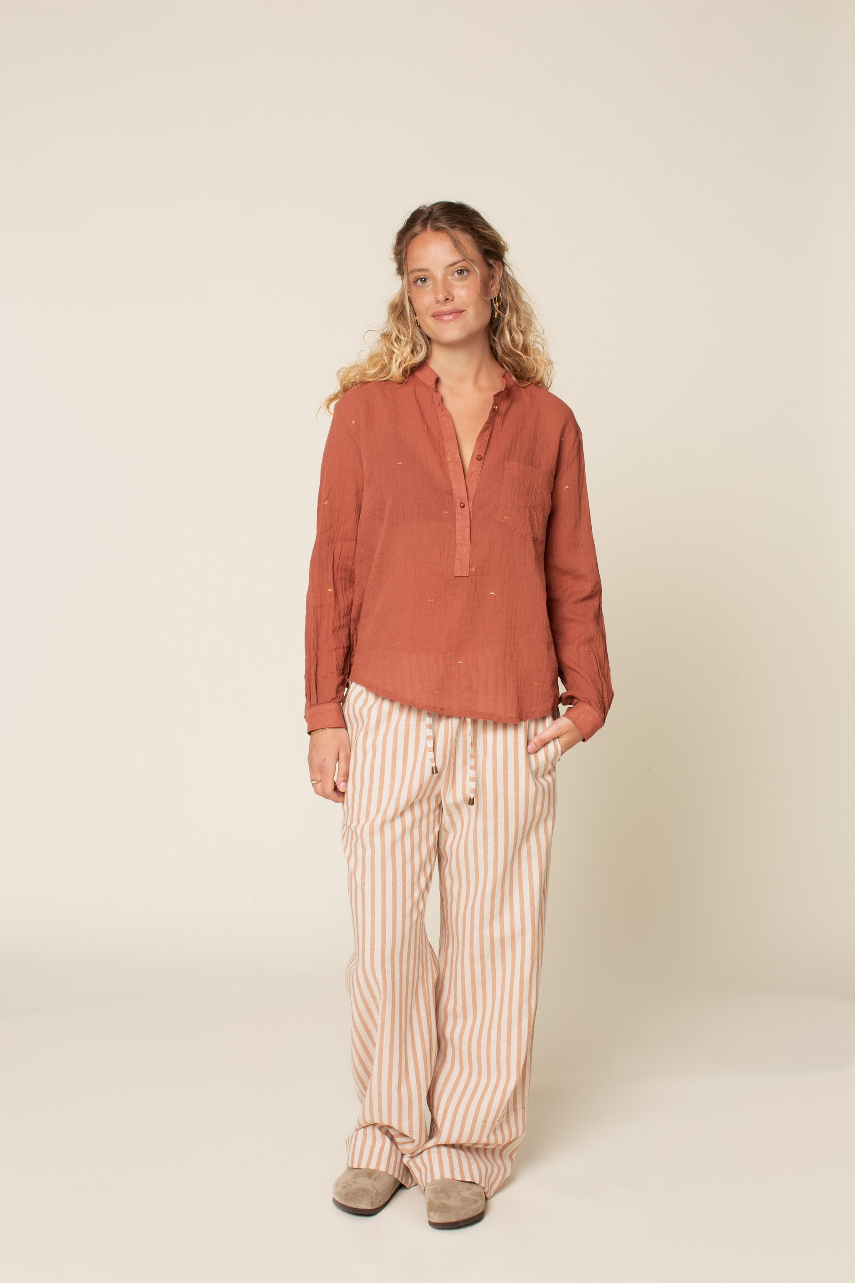 Woman wearing the High Waist Pants sewing pattern from Wardrobe by Me on The Fold Line. A trouser pattern made in cotton, viscose, linen, canvas or denim fabrics, featuring a pull-on style, elasticated paper bag waist with drawstring, back patch pockets,