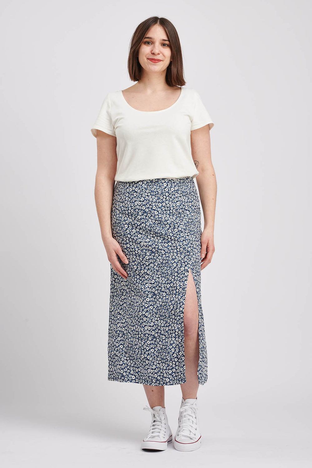 Woman wearing the Rachel Skirt sewing pattern from I AM Patterns on The Fold Line. A skirt pattern made in tencel, viscose, lightweight denim, cotton lawn, crêpe, chambray, cupro, linen, satin, and silk fabrics, featuring a mid-thigh front slit, slightly