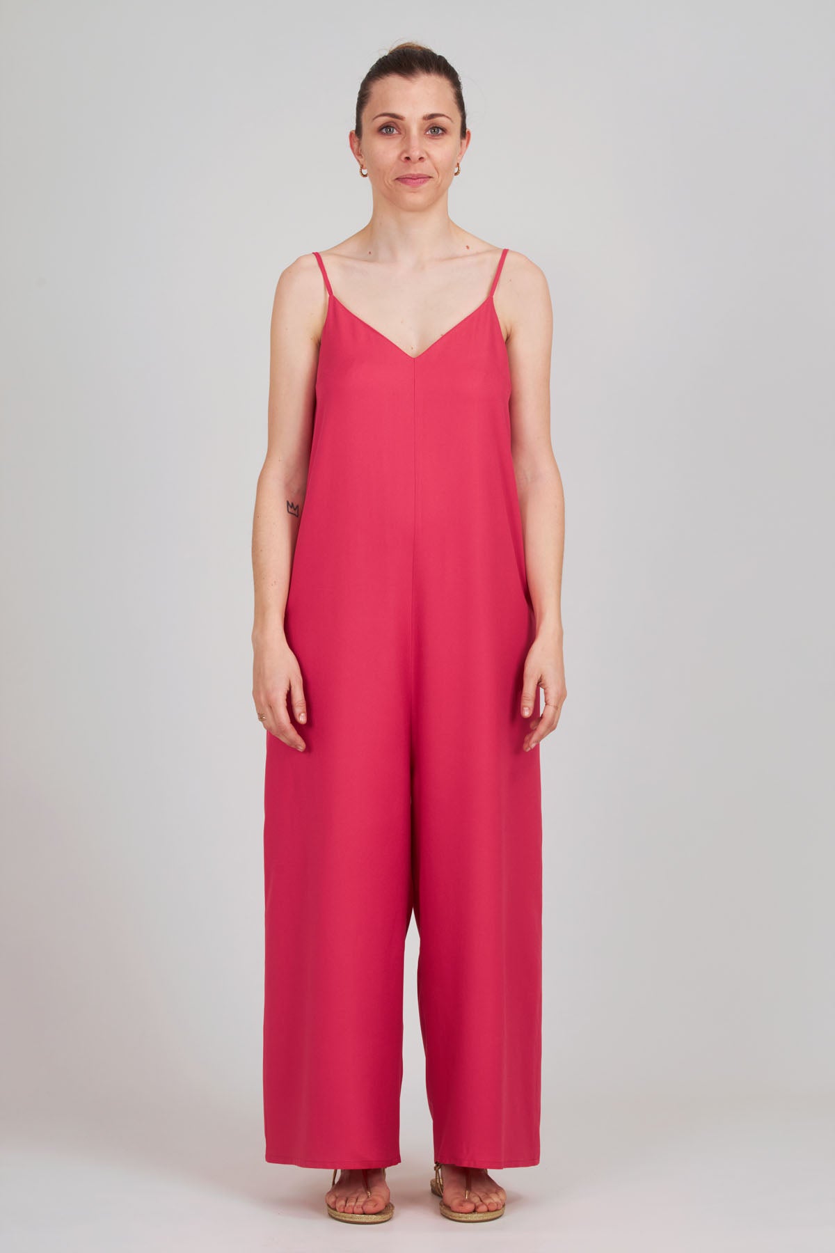 Woman wearing the Valérie Jumpsuit sewing pattern from I AM Patterns on The Fold Line. A jumpsuit pattern made in silk, viscose, Tencel, double gauze, seersucker, lightweight crepe, satin, linen, or lightweight chambray fabric, featuring a relaxed fit, v-