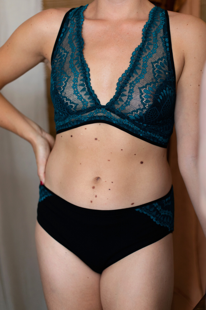 Woman wearing the Josie Bra and Pants sewing pattern from Made My Wardrobe on The Fold Line. A bra and pants pattern made in medium weight knit fabrics, featuring a bra with cross back straps, underband, hook and eye closure. The classic briefs have full
