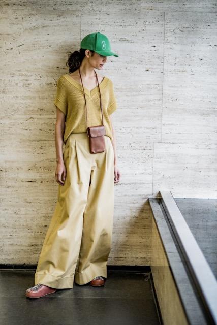Woman wearing the Kenza Trousers sewing pattern from Fibre Mood on The Fold Line. A trousers pattern made in poplin, cotton twill, crepe, wool blends, polycotton, corduroy, denim, leather, or linen fabric, featuring wide legs with double pleats, a waist f